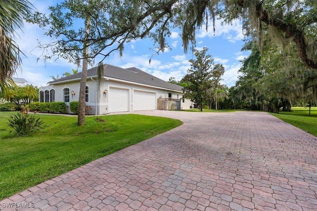 ranch-style home featuring a front yard and a garage