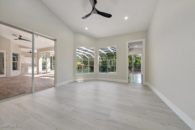 empty room featuring light hardwood / wood-style flooring and vaulted ceiling