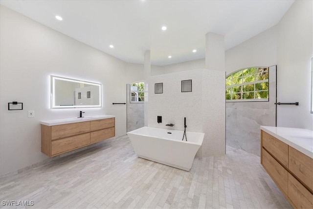 bathroom featuring vanity, a bathing tub, wood-type flooring, and tile walls