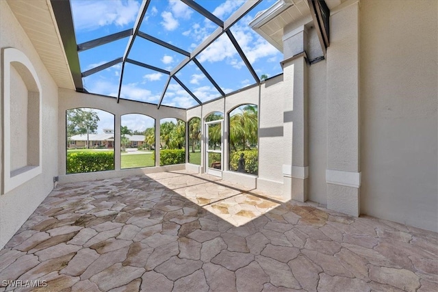 view of patio featuring a lanai