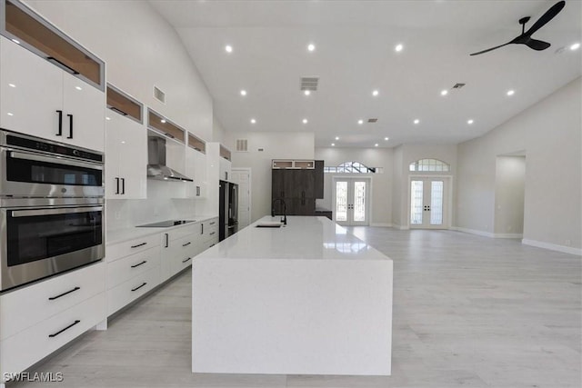 12800 Treeline Ct, North Fort Myers, FL 33903 - kitchen with modern cabinets, stainless steel appliances, wall chimney range hood, white cabinets, and recessed lighting