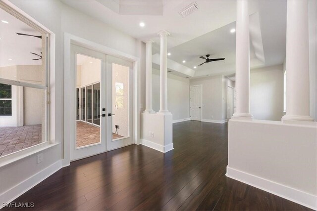 12800 Treeline Ct, North Fort Myers, FL 33903 - unfurnished room with decorative columns, ceiling fan, a raised ceiling, wood finished floors, and recessed lighting