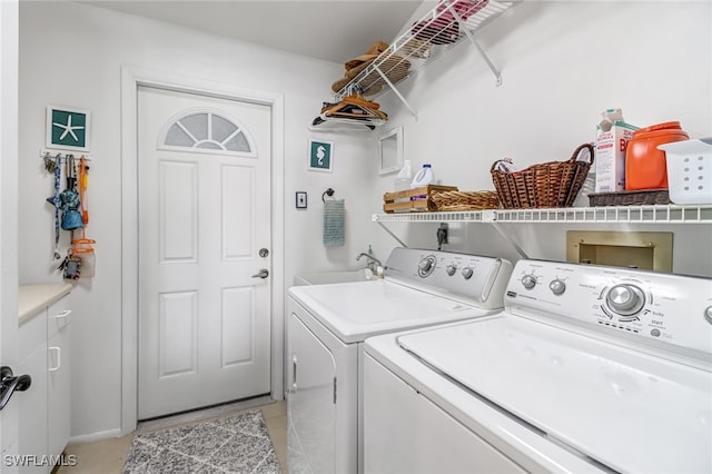 laundry area with washing machine and dryer, sink, and light tile patterned floors