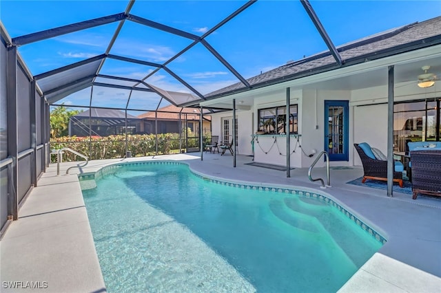 view of pool with french doors, ceiling fan, glass enclosure, and a patio area