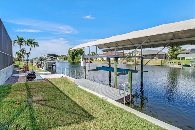 dock area with a water view, a yard, and a lanai