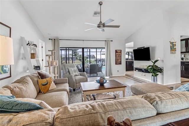 tiled living room featuring high vaulted ceiling and ceiling fan