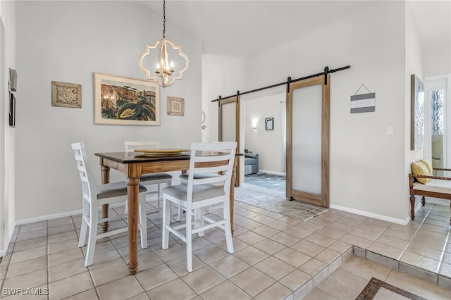 dining space with a barn door, light tile patterned floors, lofted ceiling, and an inviting chandelier