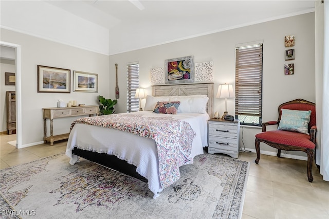 bedroom with light tile patterned flooring, vaulted ceiling, and ornamental molding