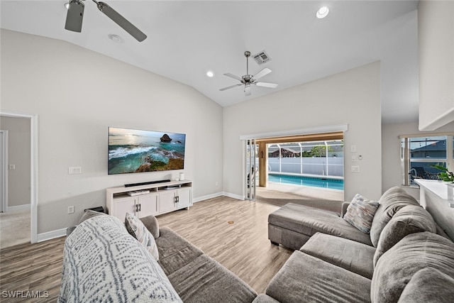 living room with wood-type flooring, ceiling fan, and lofted ceiling