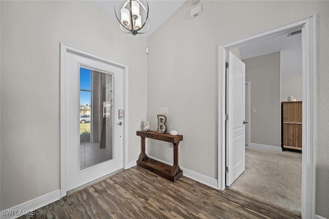 foyer entrance featuring dark hardwood / wood-style floors and vaulted ceiling