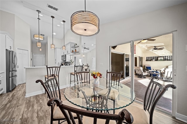 dining space featuring ceiling fan and light wood-type flooring