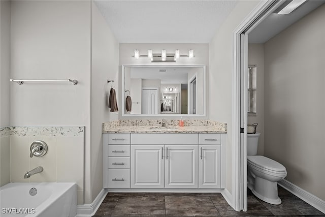 full bathroom featuring washtub / shower combination, a textured ceiling, vanity, and toilet