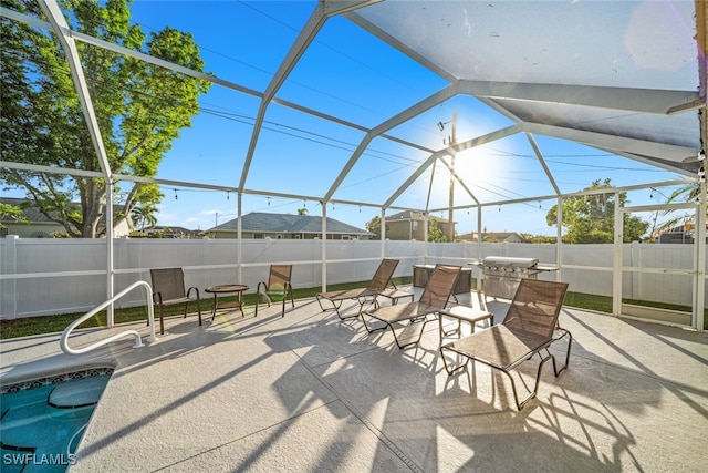 view of patio with glass enclosure