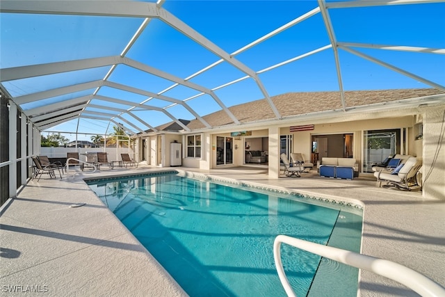 view of pool with ceiling fan, a patio area, an outdoor hangout area, and glass enclosure