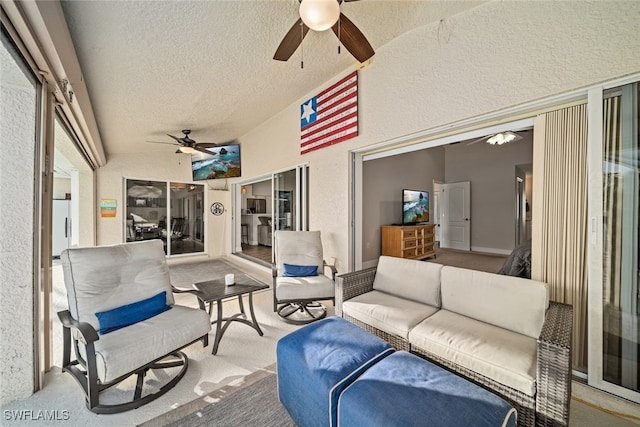 sunroom with ceiling fan and lofted ceiling