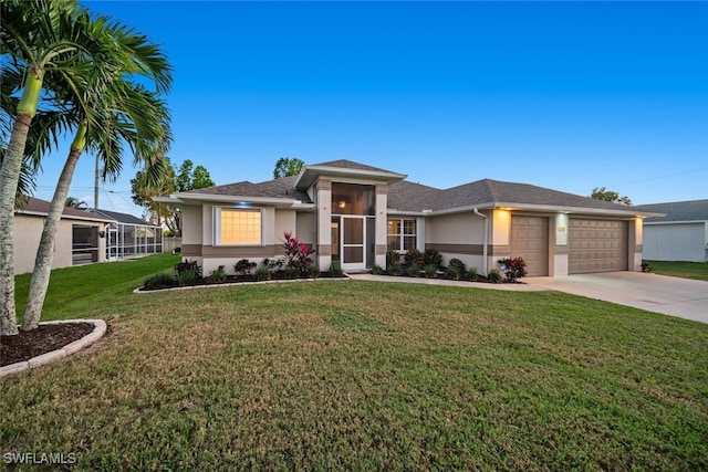 prairie-style home with a garage and a front lawn