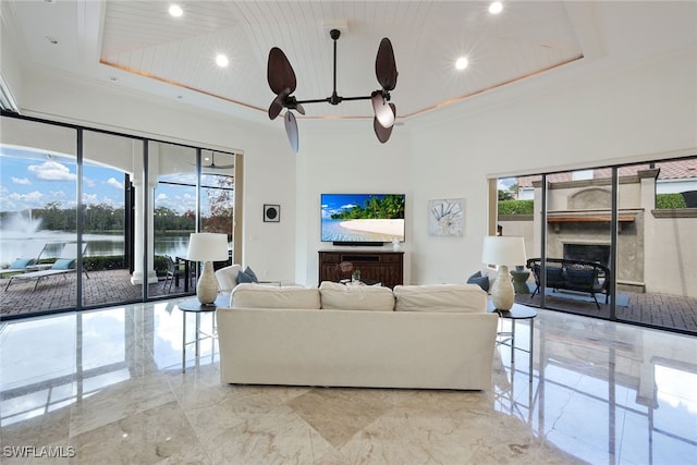 living room featuring crown molding and a towering ceiling