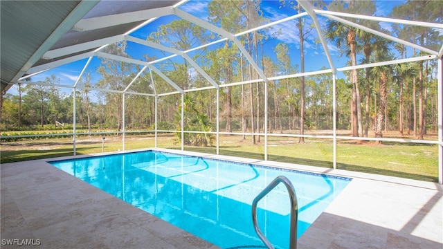 view of pool with a yard, a patio area, and glass enclosure