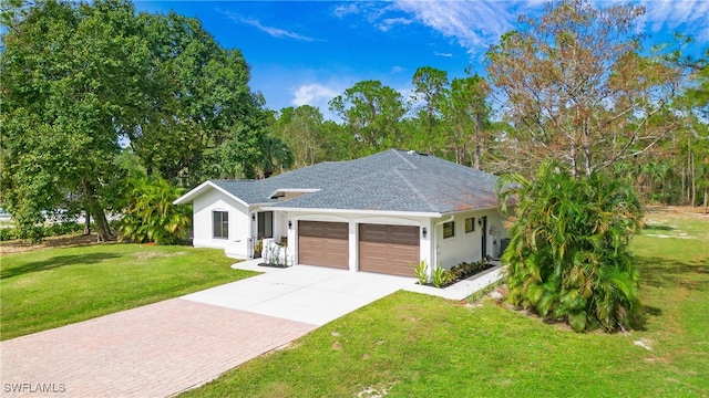 ranch-style home with a garage and a front lawn