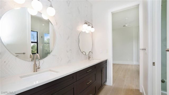 bathroom with vanity, a shower, and wood-type flooring