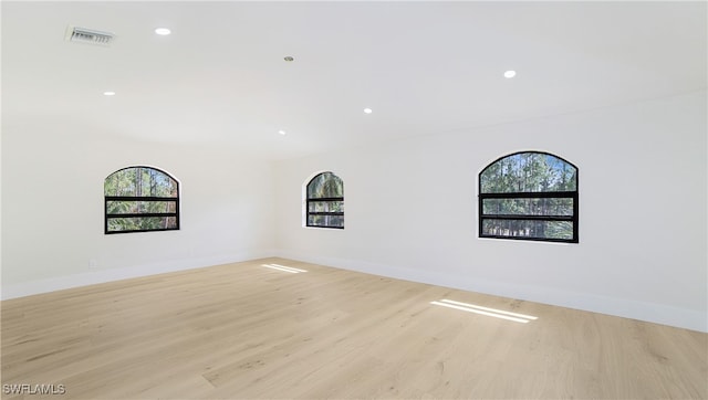 empty room with light hardwood / wood-style flooring