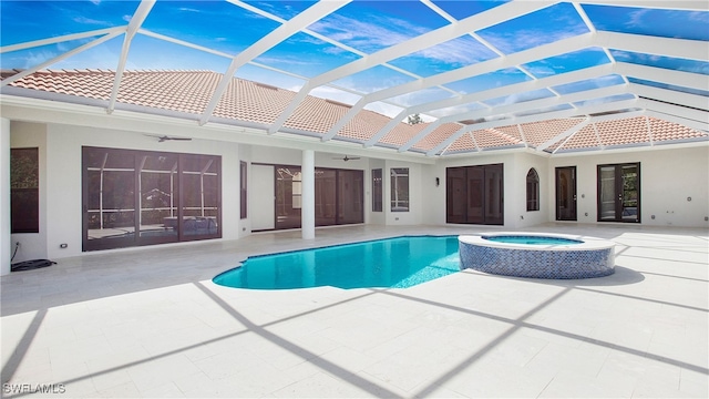 view of swimming pool with an in ground hot tub, ceiling fan, a lanai, and a patio