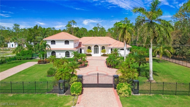 mediterranean / spanish-style home with a front lawn