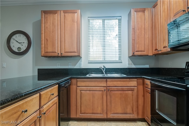 kitchen with light tile patterned floors, ornamental molding, dark stone countertops, black appliances, and sink