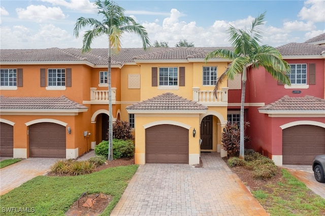 view of front of home with a balcony and a garage