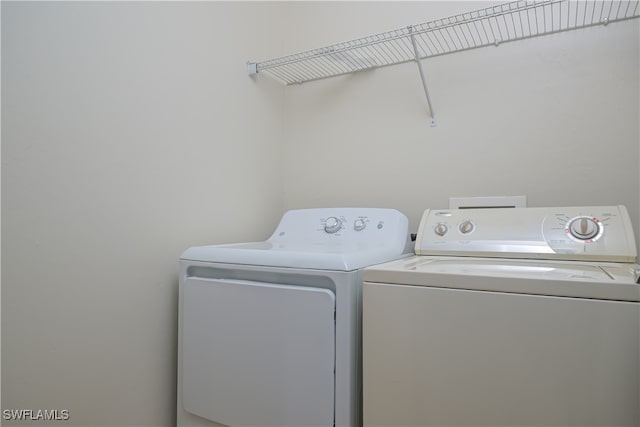 washroom featuring washer and clothes dryer