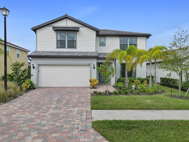 view of front of house with a front yard and a garage