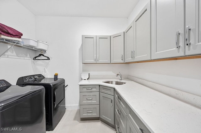 laundry room with cabinets, sink, separate washer and dryer, and light tile patterned floors