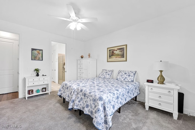 carpeted bedroom featuring ceiling fan and ensuite bath