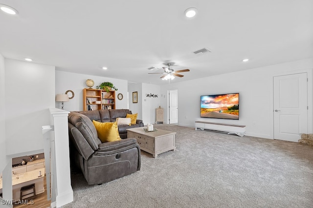 carpeted living room with ceiling fan