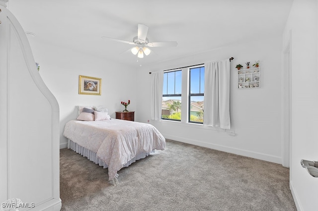 bedroom featuring ceiling fan and carpet