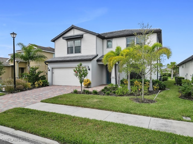 view of front of home featuring a front yard and a garage