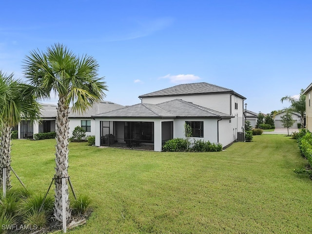 back of property featuring a yard, a sunroom, and cooling unit