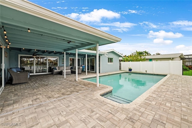 view of swimming pool featuring a patio, an outdoor hangout area, and ceiling fan