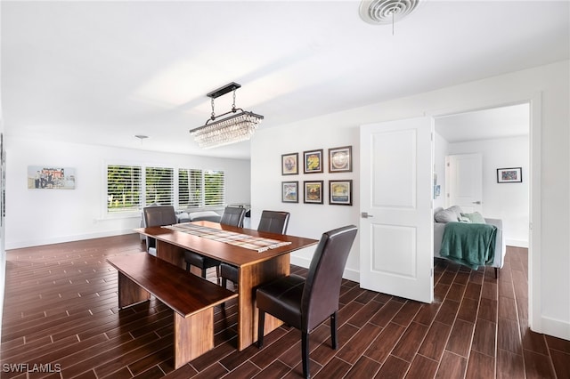 dining room with dark hardwood / wood-style flooring