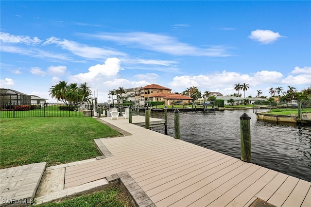 dock area with a water view and a yard