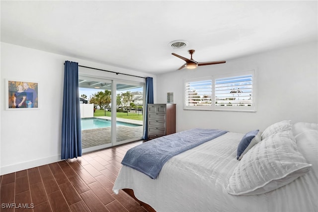 bedroom featuring dark wood-type flooring, multiple windows, access to outside, and ceiling fan