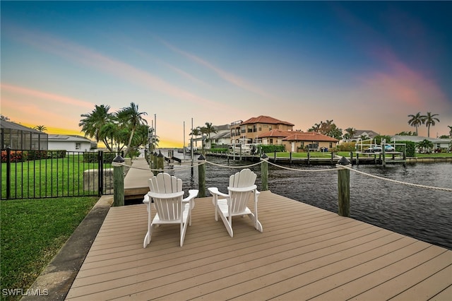 dock area featuring a yard and a water view