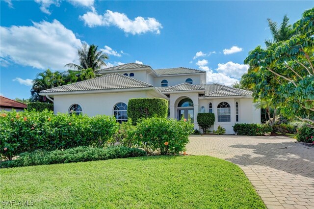 mediterranean / spanish home with a front yard