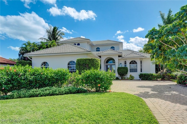 mediterranean / spanish-style home with a front yard