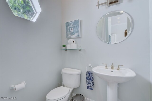 bathroom featuring toilet and sink