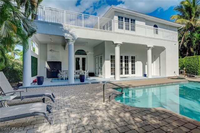 rear view of house featuring ceiling fan, a patio, and french doors