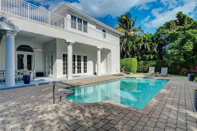 view of pool with ceiling fan, french doors, and a patio