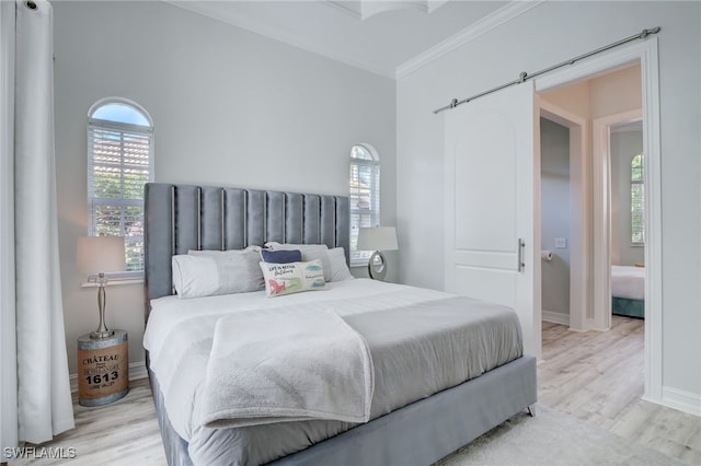 bedroom featuring light wood-type flooring and crown molding