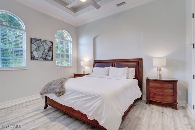 bedroom with ceiling fan, light wood-type flooring, and crown molding