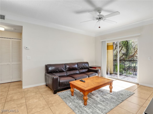 tiled living room with ornamental molding, a textured ceiling, and ceiling fan